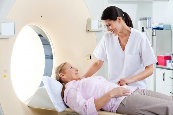 MRI radiologic technician smiling mature female patient