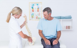 female chiropractor with patient