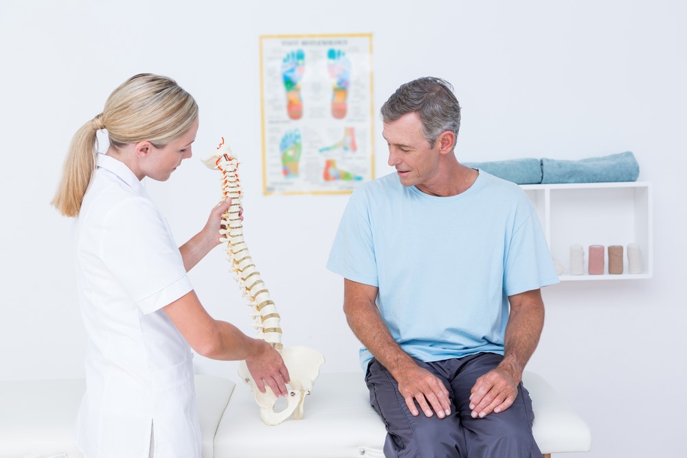female chiropractor with patient