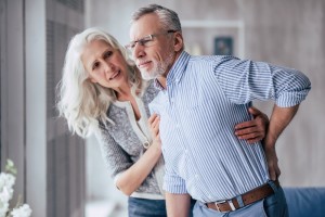 What is causing my back pain? This image shows a man struggling with extreme pain in his lower back.